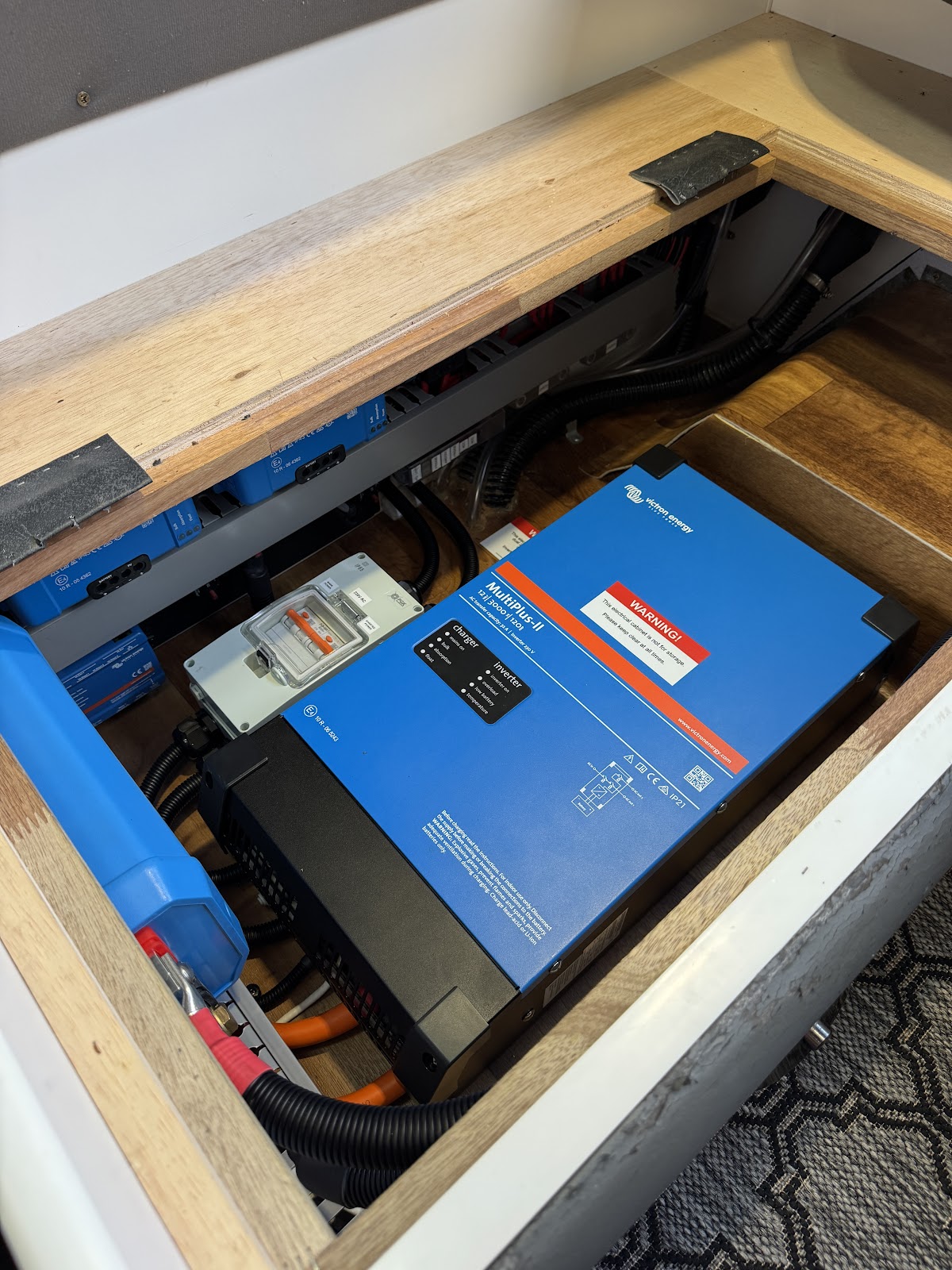 Victron inverter charger fitted under the seat base